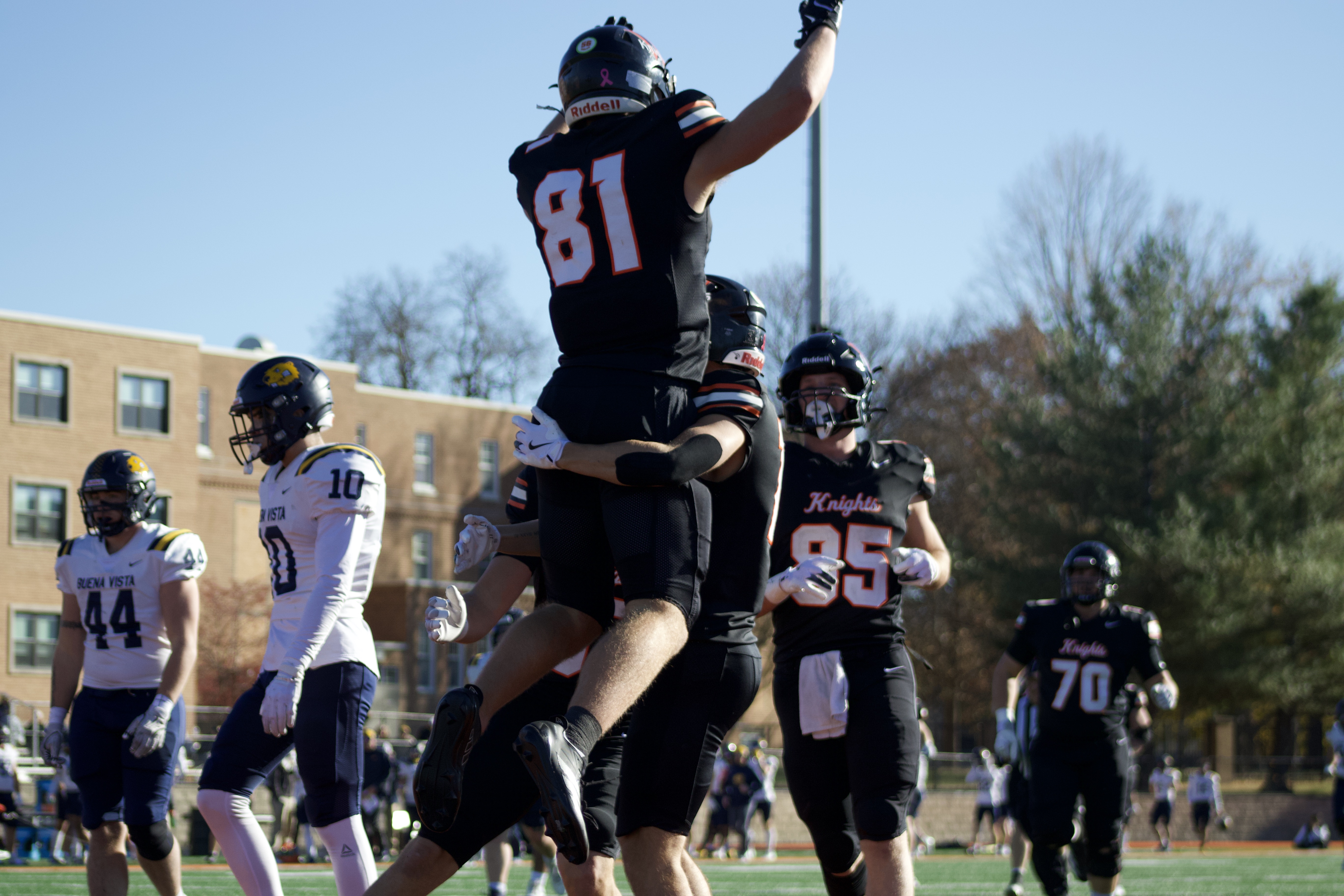 Tight end Sam Heither is lifted in the air after scoring a touchdown. Photo by Madi Petersen.